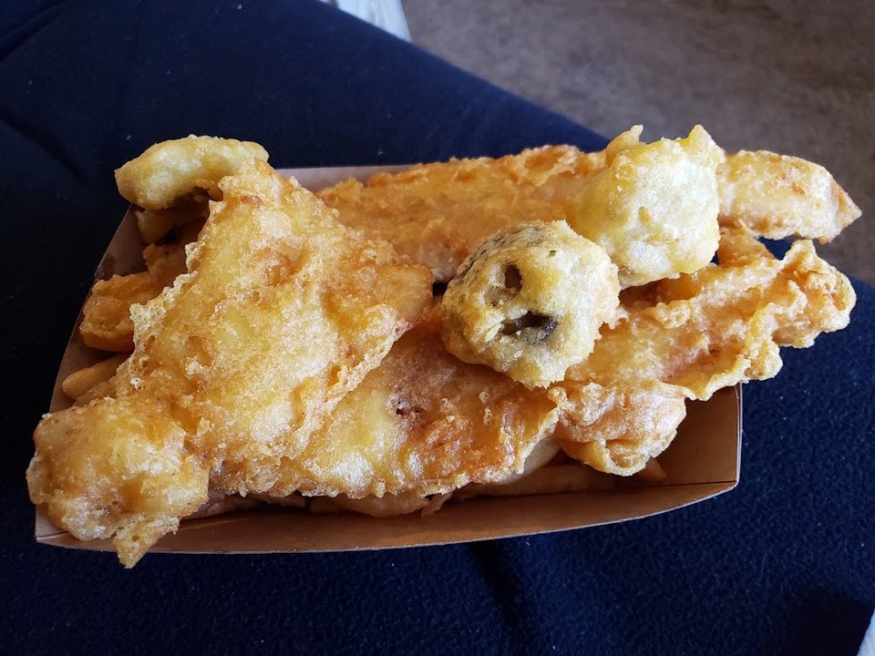 Menu board with fish, chips, and chicken options.